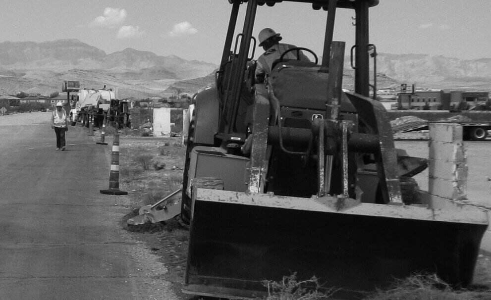 Utiliy worker driving front loader